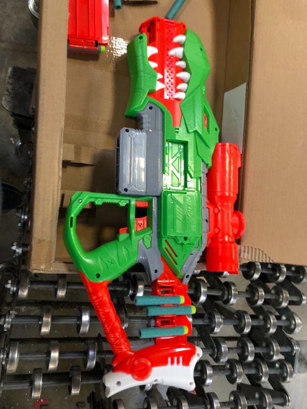 Photo 2 of NERF DinoSquad Rex-Rampage Motorized Dart Blaster, 10-Dart Clip, 20 Official Darts, 10-Dart Storage- T-Rex Dinosaur Design , Red
