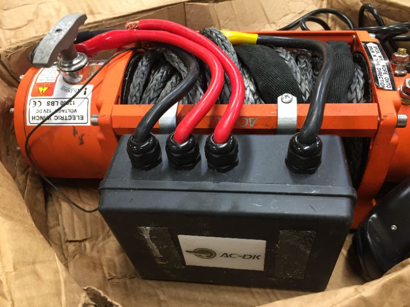Photo 2 of AC-DK 13500 lbs Electric Winch 12V DC Water Proof IP67 Recovery Winch with Synthetic Rope Orange Color Come with Overload Protection Winch Dust Cover and 2 Wireless Remotes
