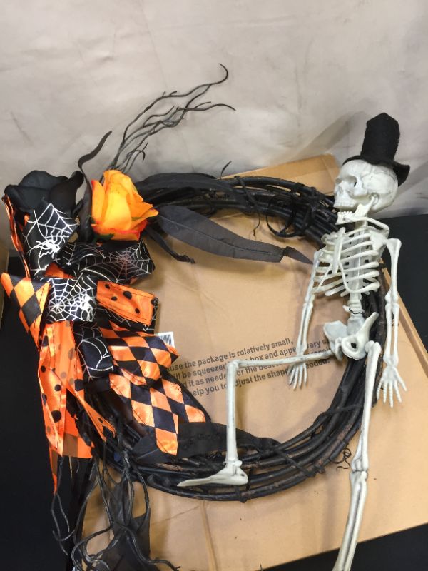 Photo 2 of 
PIKRONSH 14 Inch Halloween Grapevine Wreath with Scary Skeleton Artificial Roses Leaves and Bowknots, Front Door Wall Window Halloween Decoration