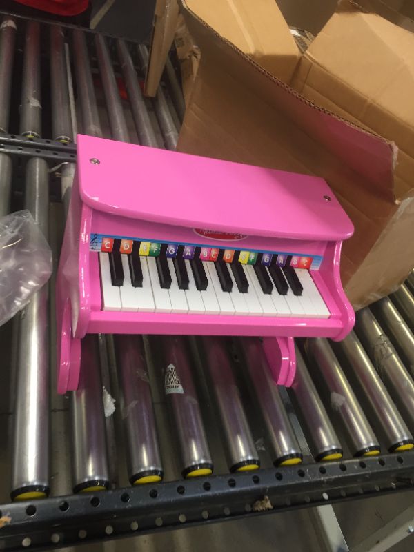 Photo 2 of Melissa & Doug Learn-to-Play Pink Piano With 25 Keys and Color-Coded Songbook
