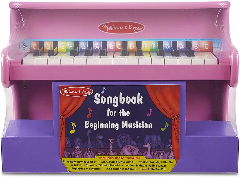 Photo 1 of Melissa & Doug Learn-to-Play Pink Piano With 25 Keys and Color-Coded Songbook
