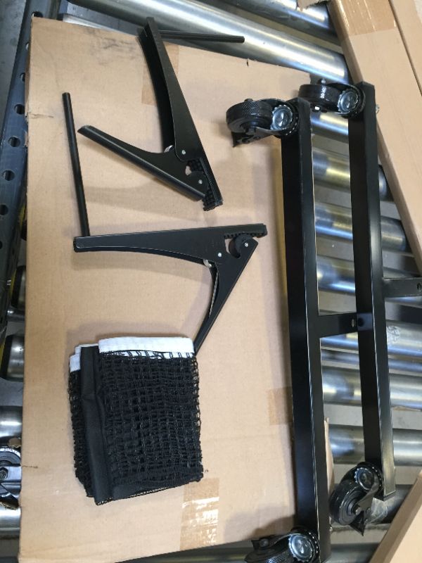 Photo 4 of JOOLA Inside - Professional MDF Indoor Table Tennis Table with Quick Clamp Ping Pong Net and Post Set - 10 Minute Easy Assembly - Ping Pong Table with Single Player Playback Mode
corner damage
