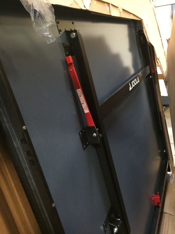 Photo 8 of JOOLA Inside - Professional MDF Indoor Table Tennis Table with Quick Clamp Ping Pong Net and Post Set - 10 Minute Easy Assembly - Ping Pong Table with Single Player Playback Mode
corner damage

