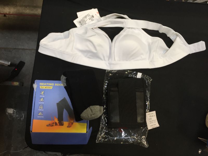 Photo 1 of Clothing pack, heating socks, women's sports bra size Asia Large, and a waist trainer belt