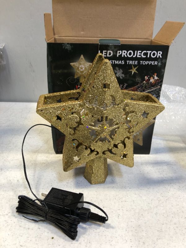 Photo 2 of Christmas Tree Topper Projector, LED Star Tree Topper Light , Glitter Gold Star Topper Projector with Rotating Star Projection for Indoor Christmas Tree Decor, Xmas Decorations
