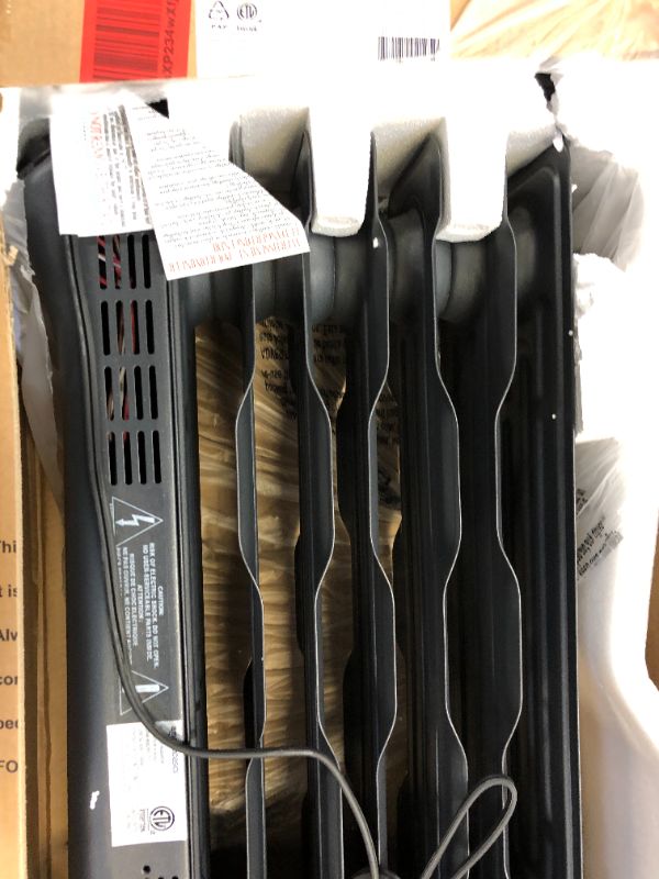 Photo 1 of Amazon Basics Portable Radiator Heater with 7 Wavy Fins, Manual Control, Black, 1500W NO WHEELS 
