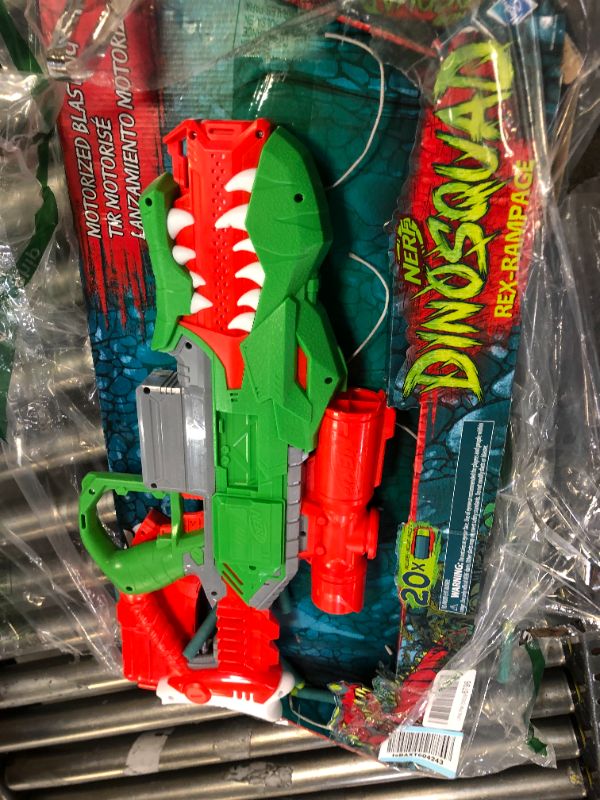 Photo 2 of NERF DinoSquad Rex-Rampage Motorized Dart Blaster, 10-Dart Clip, 20 Official Darts, 10-Dart Storage- T-Rex Dinosaur Design , Red
