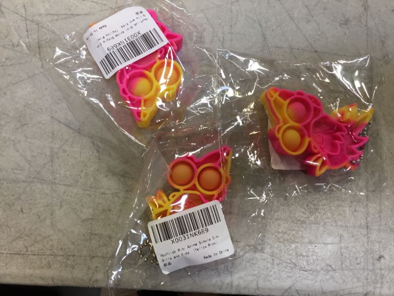 Photo 1 of Push Pop Key Chain anime Goku yellow and pink (3 pack)