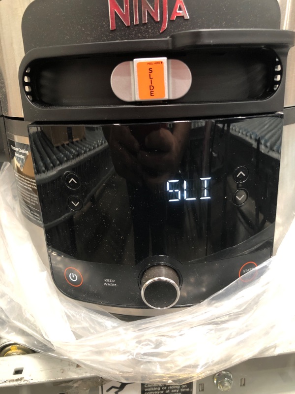 Photo 1 of Ninja OL501 Foodi 6.5 Qt. 14-in-1 Pressure Cooker Steam Fryer with SmartLid, that Air Fries, Proofs & More, with 2-Layer Capacity, 4.6 Qt. Crisp Plate & 25 Recipes, Silver/Black latch for the lid is broken and needs to be replaced or fixed before use
