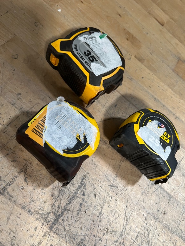 Photo 1 of **NOT REFUNDABLE** BUNDLE OF MEASURING TAPE//SOLD AS IS// THE 35 IS DAMAGED GETS STUCK SOMETIMES