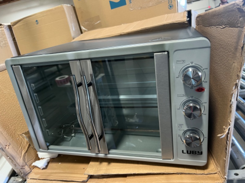 Photo 3 of LUBY Large Toaster Oven Countertop, French Door Designed, 55L, 18 Slices, 14'' pizza, 20lb Turkey, Silver
MINOR DAMAGE TO THE SIDE ITS DENTED