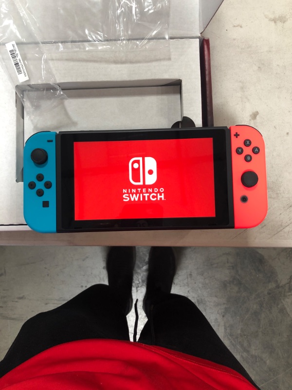 Photo 2 of Nintendo Switch with Neon Blue and Neon Red Joy?Con
