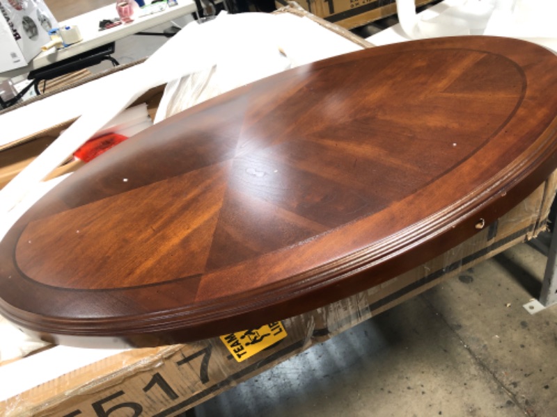 Photo 4 of (CRACKED TABLE LEG INSERTION; SCRATCHED/DENTED) Signature Design by Ashley Nestor Traditional Oval Coffee Table with Beveled Glass Top, Scrollwork Underlay and 1 Fixed Shelf, Dark Brown, 34.25"D x 48"W x 20.25"H

