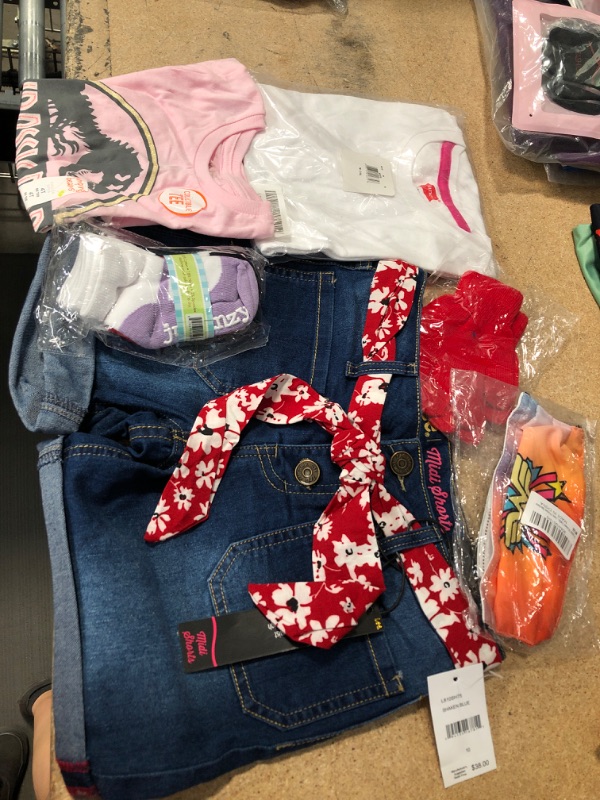 Photo 1 of **NO RETURNS/REFUNDS** - Bundle of assorted Girls Clothes Shorts: size 10, socks 12-24 months, etc. shirt 4t & M