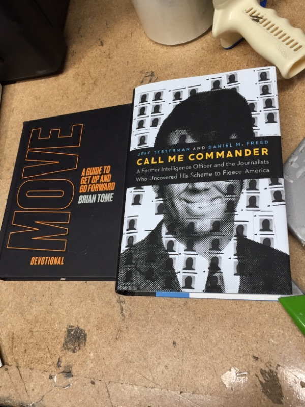 Photo 1 of 2 BOOKS 
Call Me Commander: A Former Intelligence Officer and the Journalists Who Uncovered His Scheme to Fleece America Hardcover – February 1, 2021
and
Move Devotional: A Guide to Get Up and Go Forward Hardcover – May 18, 2021
