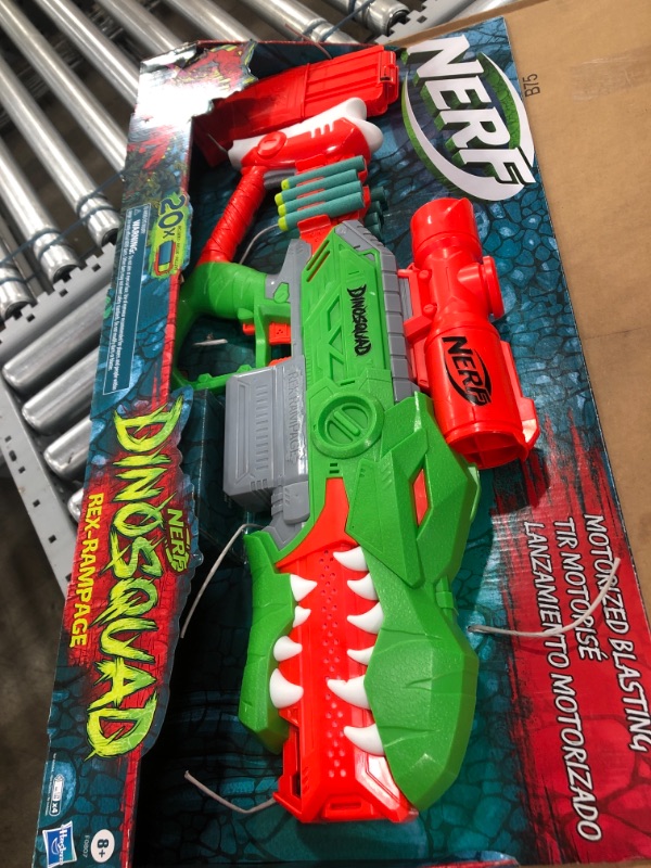 Photo 2 of NERF DinoSquad Rex-Rampage Motorized Dart Blaster, 10-Dart Clip, 20 Official Darts, 10-Dart Storage- T-Rex Dinosaur Design , Red
