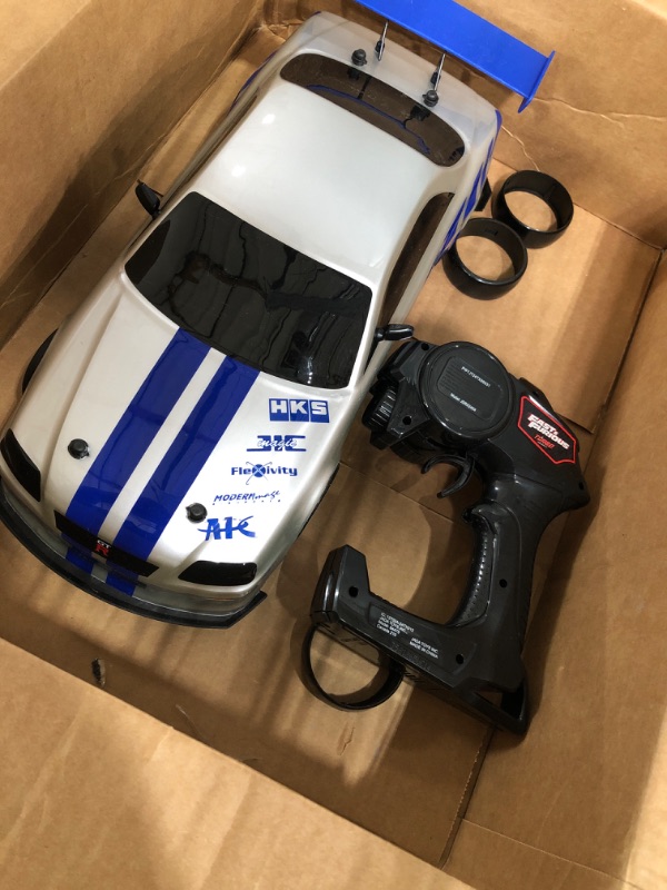 Photo 2 of Jada Toys Fast & Furious Brian's Nissan Skyline GT-R (BN34) Drift Power Slide RC Radio Remote Control Toy Race Car with Extra Tires, 1:10 Scale, Silver/Blue