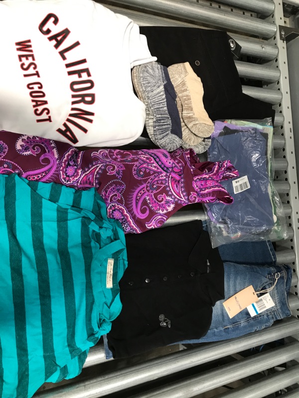 Photo 1 of **NON REFUNDABLE** SOLD AS IS 
Bundle of Womens clothing and accessories.
sizes: pants: 9L, 32/30
shirts: small to XXL.
bathing suit top: 18W