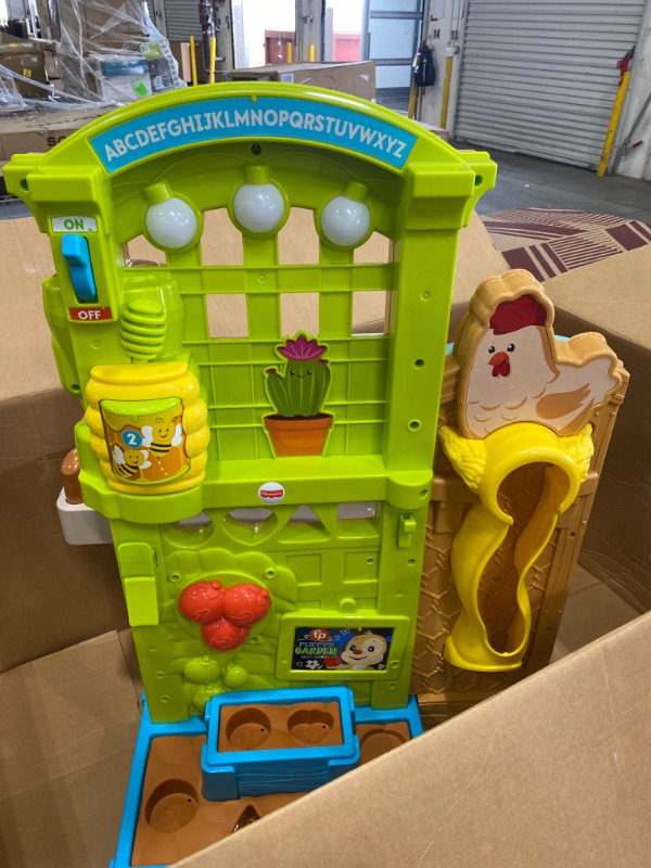 Photo 2 of Fisher-Price Laugh & Learn Grow-the-Fun Garden to Kitchen, Interactive Farm-to-Kitchen Playset for Toddlers with Music, Lights and Learning Content
