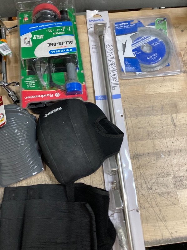 Photo 1 of **NON-REFUNDBALE** 
Miscellaneous Home Depot Items, Assorted Bath Supplies, Locks, Knee Pads and Back Brace, Curtain Rod, Goggles and Saw Blade 