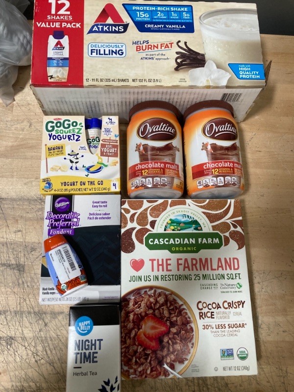 Photo 1 of **NON-REFUNDABLE** 
BEST BY DATES FROM FEB 2022-JAN 2023 
Assortment of Food Items; Cereal, Night Time Tea, Fondant, Chocolate Mix, Gogo Squeeze Banana Yogurt and Atkins Protein Smoothies 