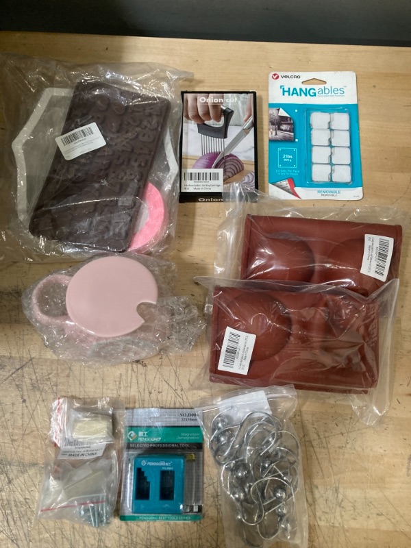 Photo 1 of **NON-REFUNDABLE**
Assorted Home Goods; Molds, Cutting Tools, Cabinet Handles, Poster Tacks, Curtain Hangers and a Mug 