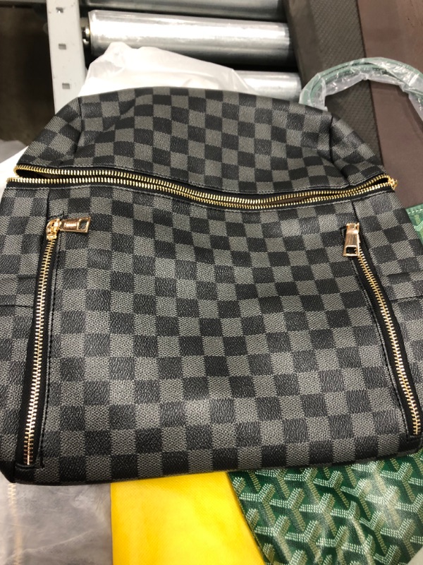 Photo 1 of BLACK AND CHECKERED BACKPACK BAG