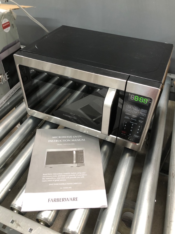 Photo 2 of ***PARTS ONLY*** Farberware Classic FMO07AHTBKJ 0.7 Cu. Ft. 700-Watt Microwave Oven with LED Lighting, Brushed Stainless Steel
