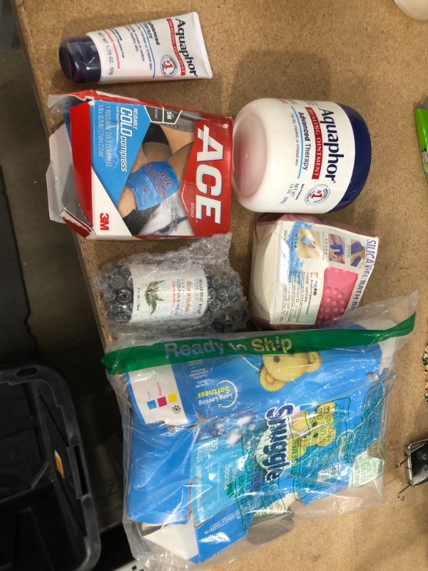 Photo 1 of **NO REFUNDS/RETURNS** - Bundle of assorted home goods (Aquaphor, cold compress, snuggle)