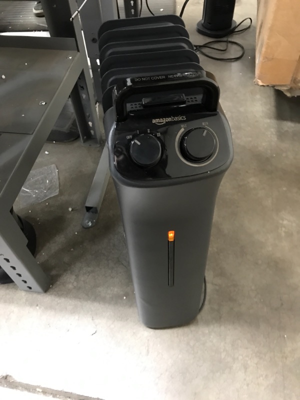 Photo 2 of Amazon Basics Portable Radiator Heater with 7 Wavy Fins, Manual Control, Black, 1500W
