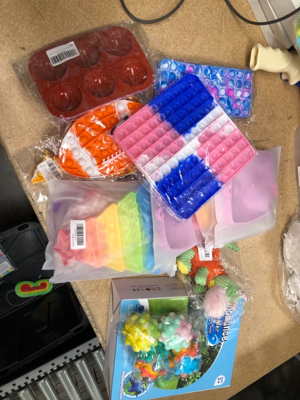 Photo 1 of ASSORTED BAG OF TOYS FOR KIDS, SPRINKLER POOL/POP FIDGETS