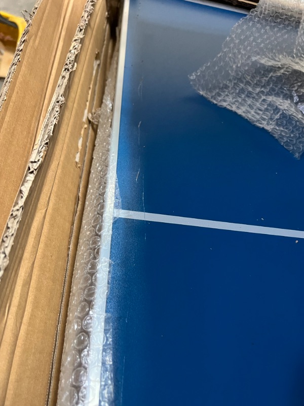 Photo 1 of INCOMPLETE INLUDES ONLY THE TABLE**GoSports 6’x3’ Mid-Size Table Tennis Game Set - Indoor/Outdoor Portable Table Tennis Game with Net, 2 Table Tennis Paddles and 4 Balls, Blue 
IT IS DAMAGEDE HAS A WHOLE ON TABLE SEE PICTURES
