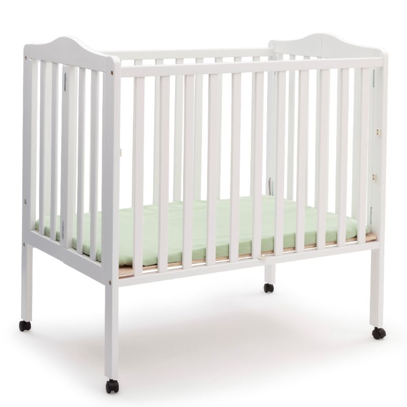 Photo 1 of Delta Children Folding Portable Mini Crib with 1.5-inch Mattress, White
