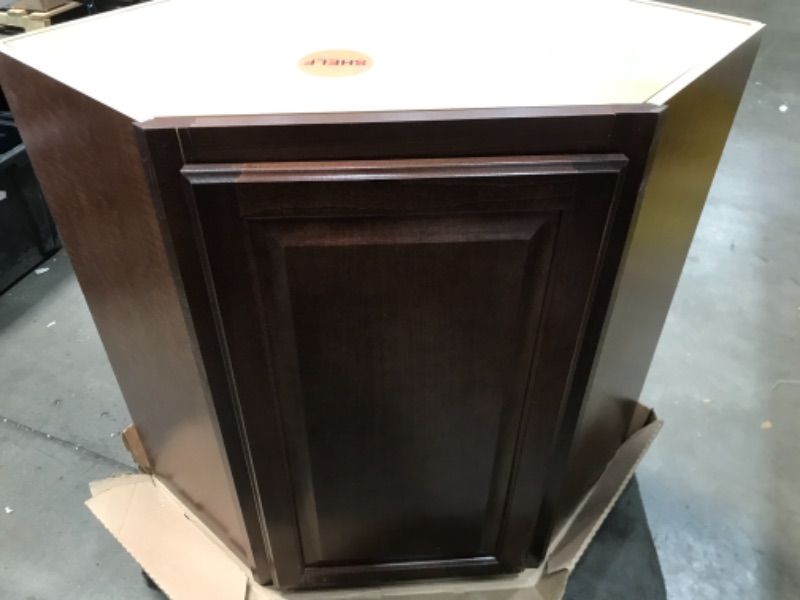 Photo 2 of **LIGHTLY DAMAGED TO BOTTOM** *Hampton Bay
Hampton Assembled 24x30x12 in. Diagonal Corner Wall Kitchen Cabinet in Cognac