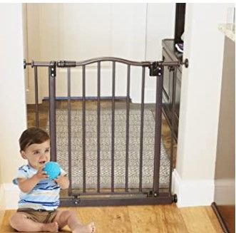 Photo 1 of Toddleroo by North States 38.25” wide Portico Arch Baby Gate: Decorative heavy duty metal safety gate with one hand operation. Pressure Mount. Fits 28.25"- 38.25" wide (28.5" tall, Bronze)
