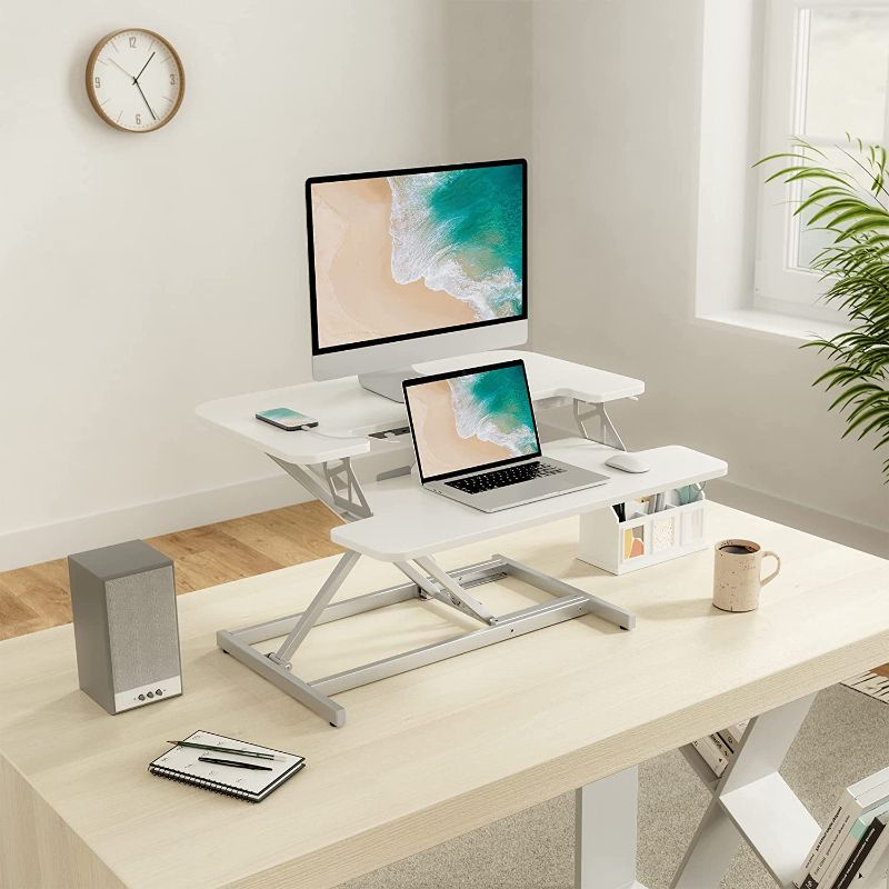 Photo 1 of FEZIBO 28” Height Adjustable Standing Desk Converter with USB Charging Port, Quick Sit to Stand Tabletop Dual Monitor, Stand Up Desk Riser for Home Office, White
