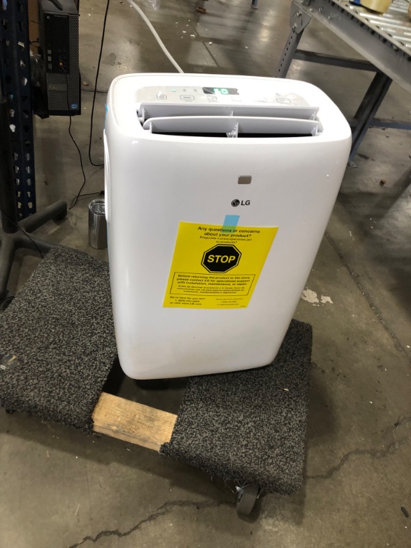 Photo 3 of (BROKEN WHEEL BASE; MISSING WHEEL BASE HARDWARE) 
6,000 BTU (DOE) 115-Volt Portable Air Conditioner with Dehumidifier Function and LCD Remote in White