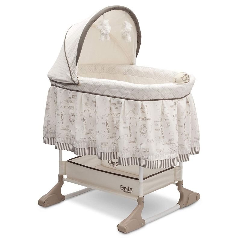 Photo 1 of Delta Children Rocking Bedside Bassinet - Portable Crib with Lights Sounds and Vibrations, Play Time Jungle
