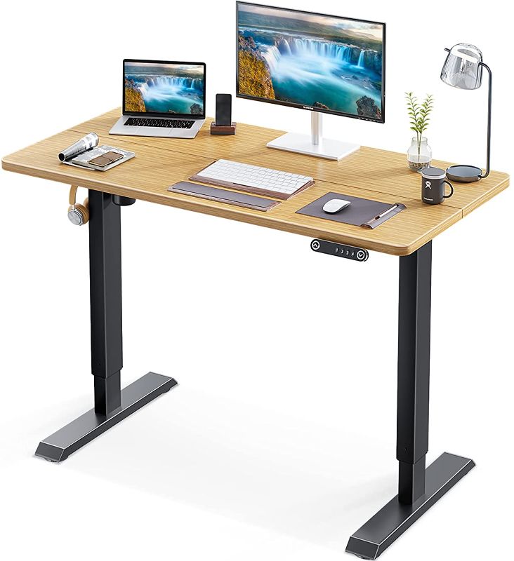 Photo 1 of ***DAMAGED*** KKL 48-inch Height Adjustable Electric Standing Desk, 48 x 24 Inches Stand Up Desk with Splice Board and Hook, Sit Stand Desk with Bamboo Top and Black Frame
