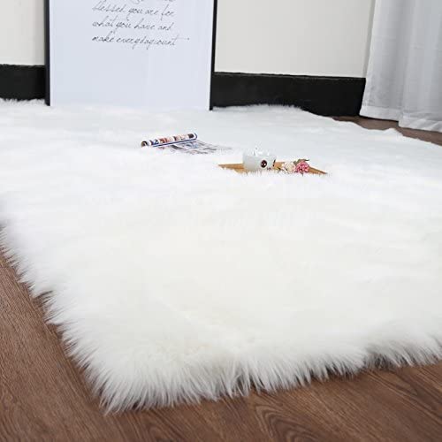 Photo 1 of HUAHOO White Faux Sheepskin Area Rug Chair Cover Seat Pad Plain Shaggy Area Rugs for Bedroom Sofa Floor Ivory White (4’ x 5' Livingroom Rug)
