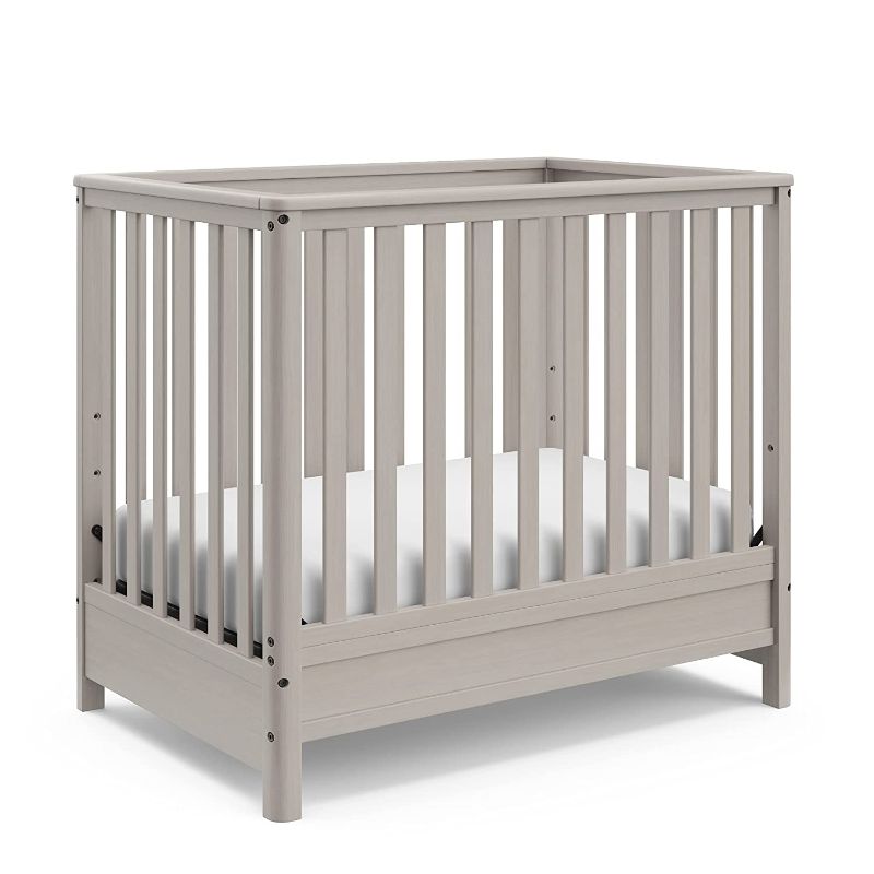 Photo 1 of Motherly by Storkcraft 5-in-1 Convertible Mini Crib with 2.75" Bonus Thick Mattress with Water-Resistant Cover, Converts to Twin-Size Bed, Non-Toxic Finish, Brushed Fog

