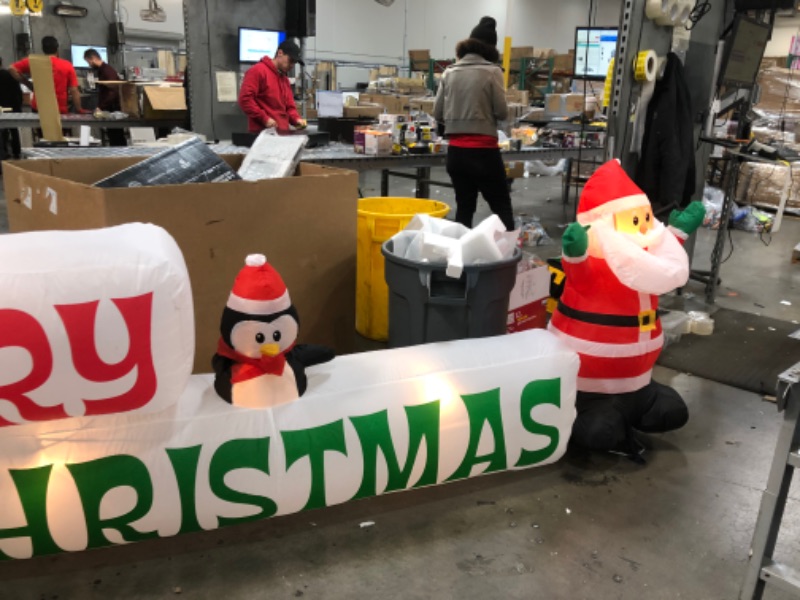 Photo 2 of Home Accents Holiday 11.5 ft Pre-Lit LED Giant-Sized Airblown Merry Christmas Sign with Santa and Penguin Scene Inflatable
