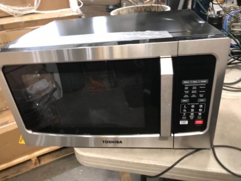 Photo 2 of DENTED IN THE BACK AND SIDE, Toshiba EC042A5C-SS Countertop Microwave Oven with Convection, Smart Sensor, Sound On/Off Function and LCD Display, 1.5 Cu.ft, Stainless Steel