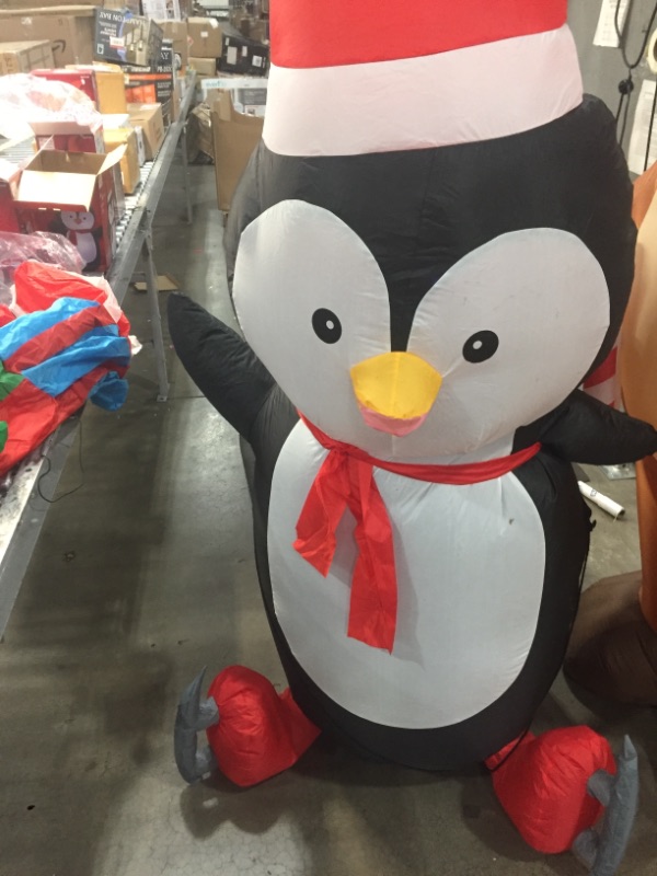 Photo 2 of Home Accents Holiday 6.5 Ft Pre-Lit LED Airblown Penguin with Skates Christmas Inflatable
