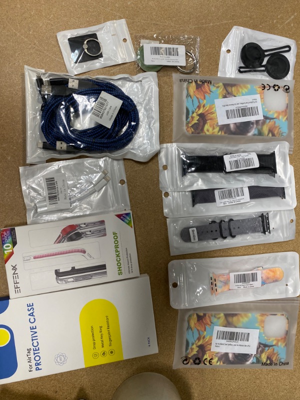 Photo 1 of **NON- REFUNDABLE** Assortment of iPhone 13 products, apple watch bands, airtag cases, and chargers 13 pack
