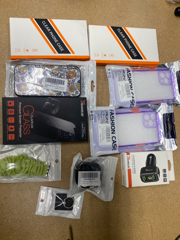 Photo 1 of **NON- REFUNDABLE** Assortment of iPhone 12 products, apple watch bands, airtag cases, and chargers
