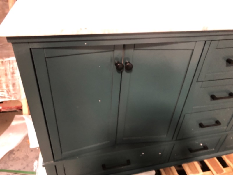 Photo 2 of "**BACK PANEL ON BATHROOM VANITY IS BROKEN IN 2 DIFFERENT AREAS, REFER TO PHOTO,LEFT CABINET DOORS CAVE INWARD, COUNTER ON RIGHT SIDE SINK HAS TWO ULTRA FINE FRACTURES**
Merryfield 61 in. W x 22 in. D x 35 in. H Bathroom Vanity in Antigua Green with Carra