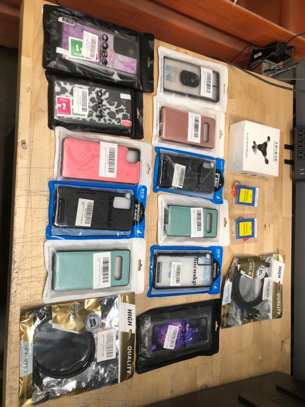 Photo 1 of **NON REFUNDABLE**
BUNDLE OF SAMSUNG CASES AND IN CAR VENT MOUNT AND  ACCESSORIES.