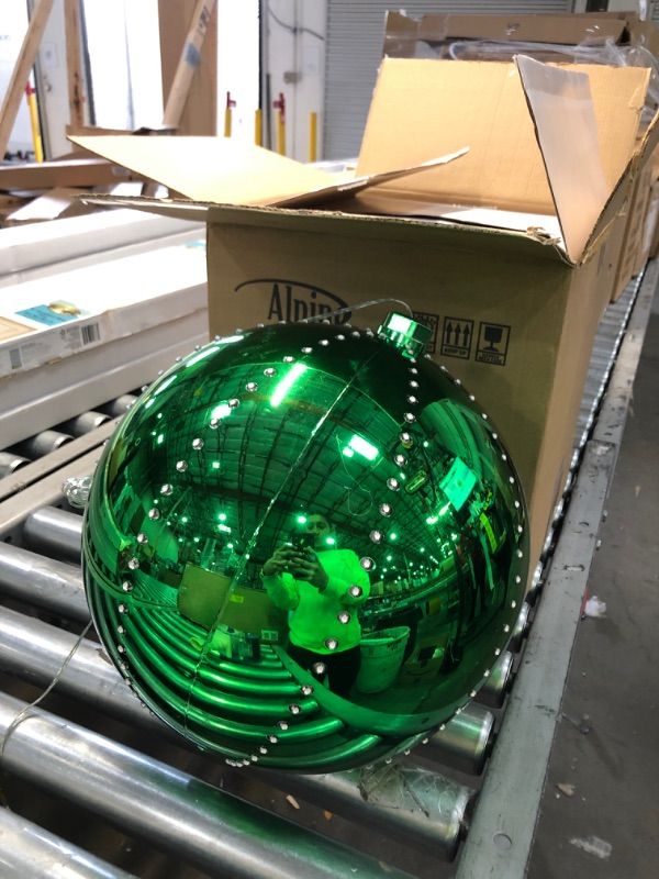 Photo 2 of Alpine Corporation LPA108L-GN Hanging Christmas Ball Ornament with Chasing LED Lights Plug-in Festive Indoor Holiday Décor, 13-Inch Tall, Green
