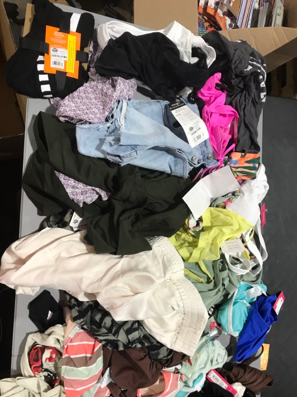 Photo 1 of lot - WOMENS SWIMSUITS AND CLOTHES VARIOUS SIZES AND STYLES ITEMS COME AS IS 